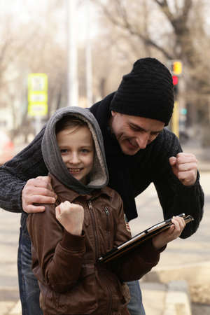 Father and son are playing on an electronic tabletの写真素材