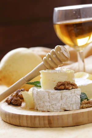 Organic camembert cheese with nuts and pearsの写真素材