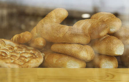 Assorted bread in shop window, low contrast