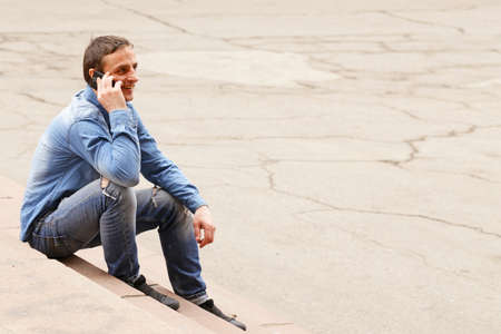 handsome young man  with mobile phone outdoorの写真素材