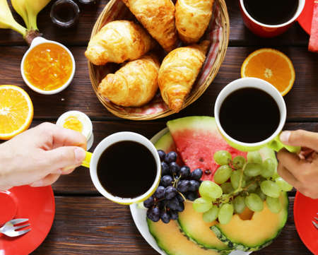 Healthy breakfast with fresh fruit, coffee, and croissantsの写真素材