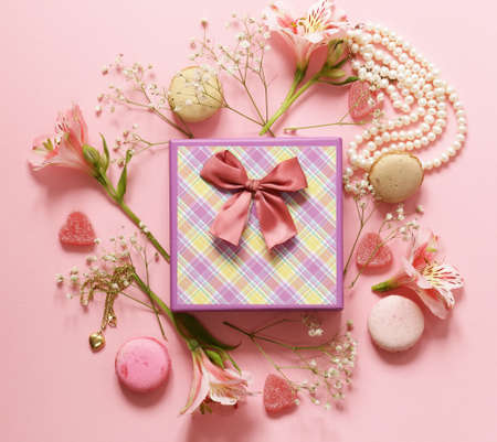 Gift box with jewelry, flowers and macaroonsの写真素材