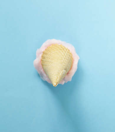 Sweet pink cotton candy in a waffle coneの写真素材