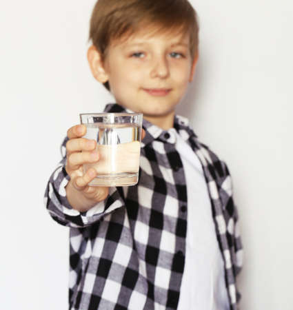 Blonde boy drinking clean water. Healthy lifestyle