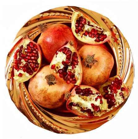 Organic ripe pomegranate on a plateの写真素材