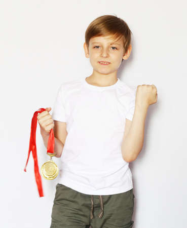 Cute blonde boy with gold medal winnerの写真素材