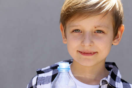 Blonde boy drinking clean water. Healthy lifestyleの写真素材