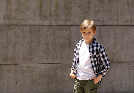 Cute blonde boy in casual clothes posingの写真素材