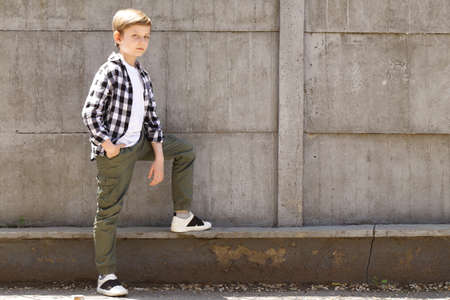 Cute blonde boy in casual clothes posingの写真素材