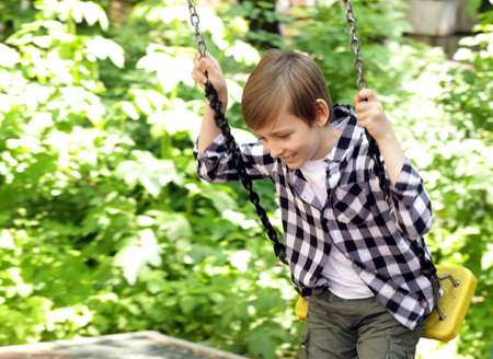 Boy playing in the playground in the parkの写真素材