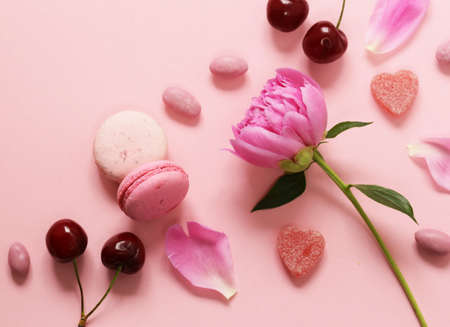Pink background with flowers and macaroons, sweet and for womenの写真素材