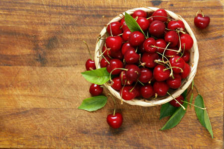 Ripe organic cherry with green leavesの写真素材