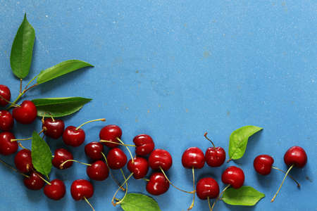 Ripe organic cherry with green leavesの写真素材
