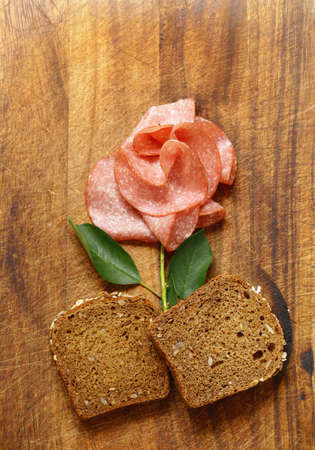 Sliced sausage salami with thyme and pepper