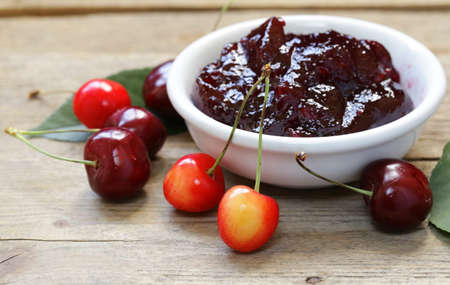 Organic cherry jam with fresh berries on the tableの写真素材