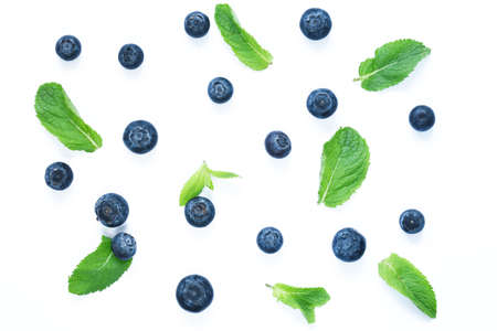 Berries of blueberries with mint leaves on a white backgroundの写真素材
