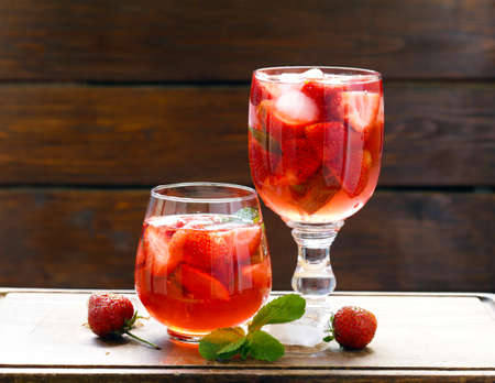Homemade summer strawberry drink with mint and ice