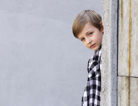 Cute blonde boy posing in casual clothesの写真素材