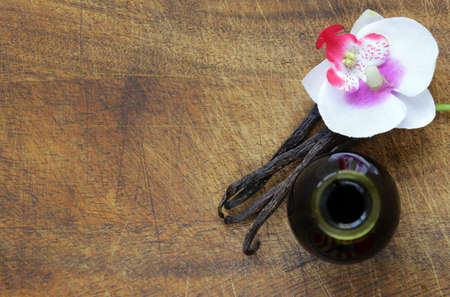 Vanilla extract in a bottle and vanilla sticks