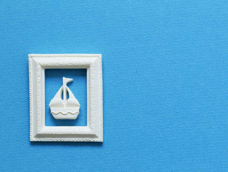 A small boat on a blue background. Travel and business conceptの写真素材