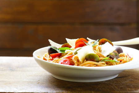 Spaghetti pasta with tomato sauce and olivesの写真素材