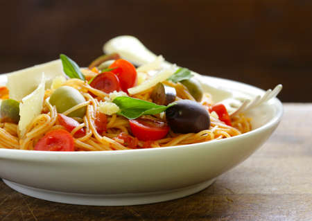 Spaghetti pasta with tomato sauce and olivesの写真素材