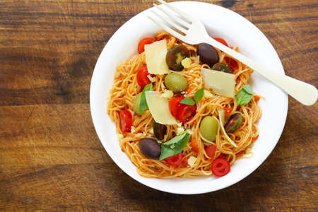 Spaghetti pasta with tomato sauce and olivesの写真素材