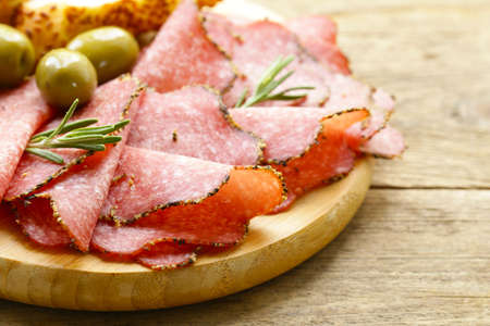 Salami pepperoni with aromatic pepper on a plate