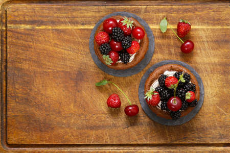 Chocolate tartlets with fresh berriesの写真素材