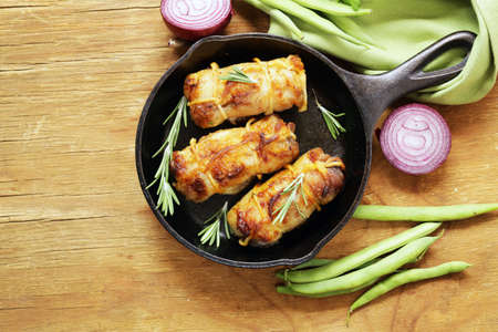 Roast rolls of chicken fillet with herbsの写真素材