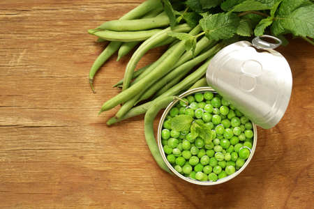 Fresh green peas on a wooden table, organic foodの写真素材