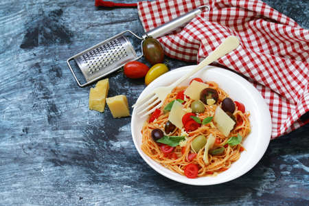 Spaghetti pasta with tomato sauce and olivesの写真素材