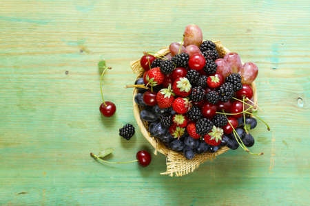 summer harvest of berries - raspberries, strawberries, grapesの写真素材