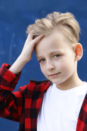 Portrait of a blonde boy casual style, fashionable haircutの写真素材