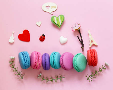 Traditional French macaroons almond cookies composition on a pink backgroundの写真素材