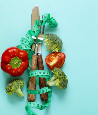 Diet concept. Measuring tape and cutleryの写真素材