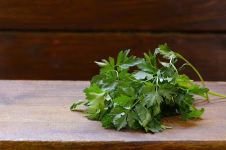 fresh green parsley on a wooden tableの写真素材