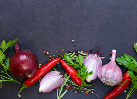 Food background - red onion, garlic, pepper, vegetables and herbsの写真素材