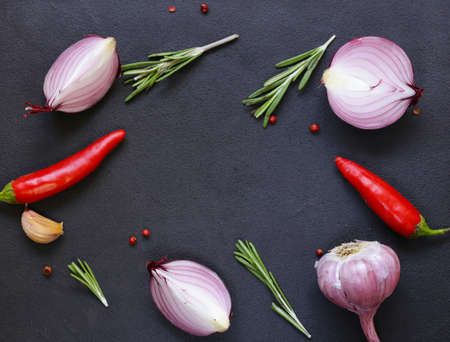 Food background - red onion, garlic, pepper, vegetables and herbsの写真素材
