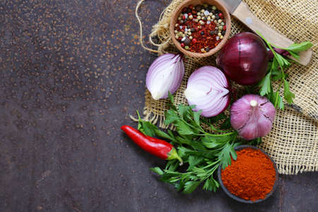 Food background - red onion, garlic, pepper, vegetables and herbsの写真素材
