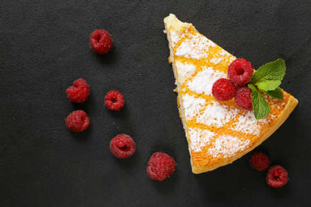 piece of cheesecake with fresh raspberries for dessert