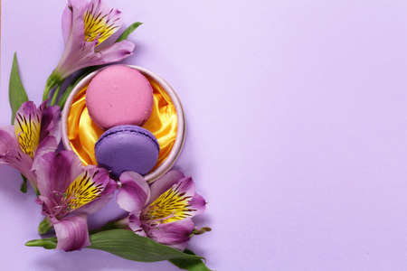 French macaroons almond cookies and alstroemeria flowers compositionの写真素材