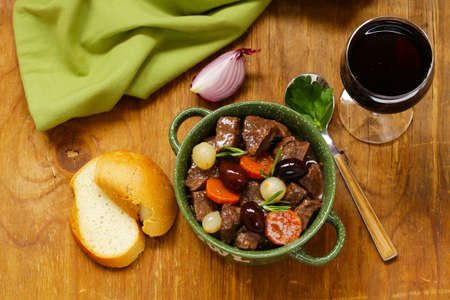 beef stew in red wine with vegetables and herbs