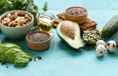healthy and nutrition food - avocado, chia and flax seeds, olive oil and vegetablesの写真素材