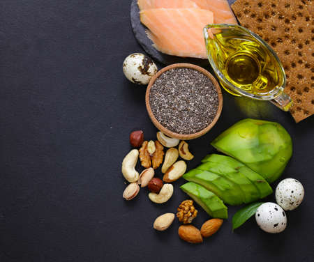 healthy and nutrition food - avocado, chia and flax seeds, olive oil and vegetables