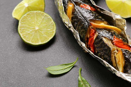 fish baked in foil with vegetables and lemonの写真素材