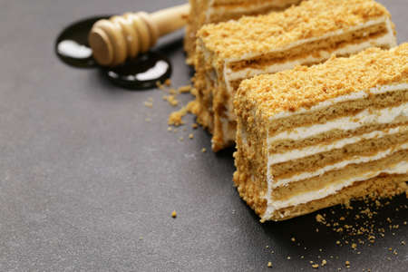 honey cake with butter cream on a stone boardの写真素材