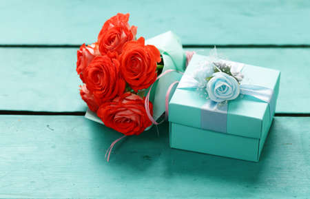 turquoise gift box and rose flowers for holidayの写真素材