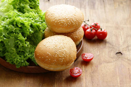 fresh homemade burger buns on a wooden table