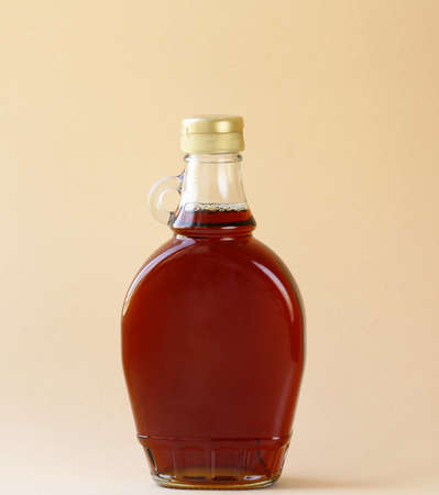 Maple syrup in a glass bottle - sweet dessert sauceの写真素材